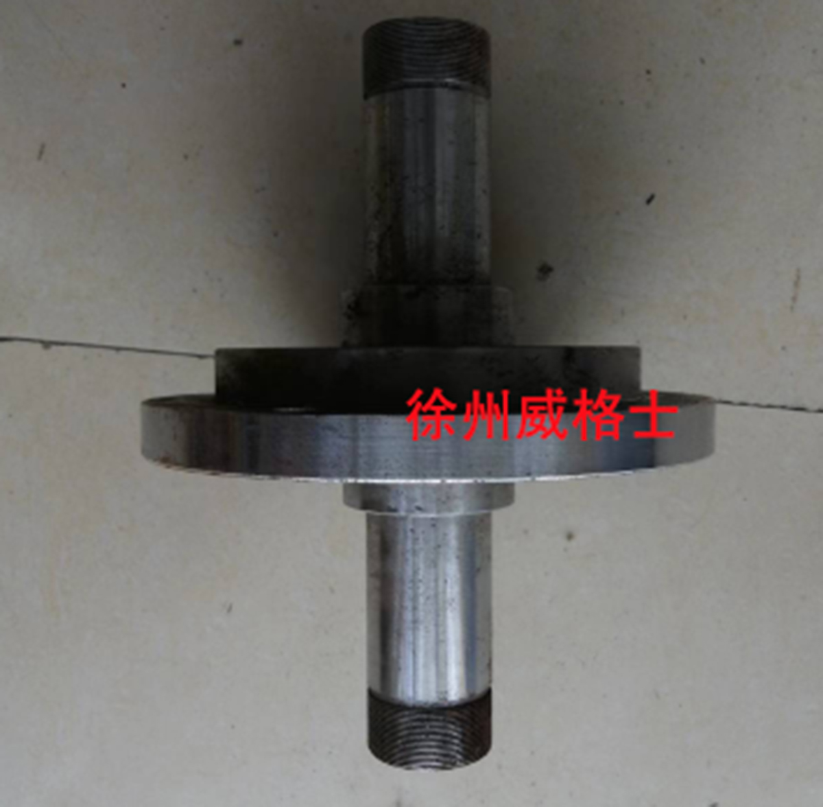 The paver stirs up the lower sprocket spacer, part